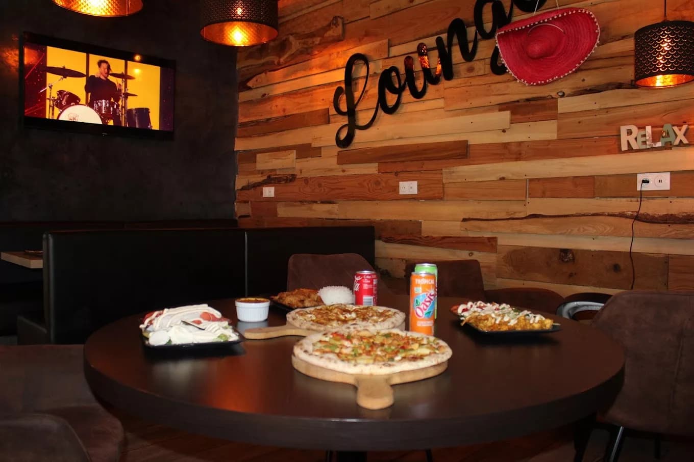Espace lounge d'un restaurant Amour de Pizza avec pizzas sur la table